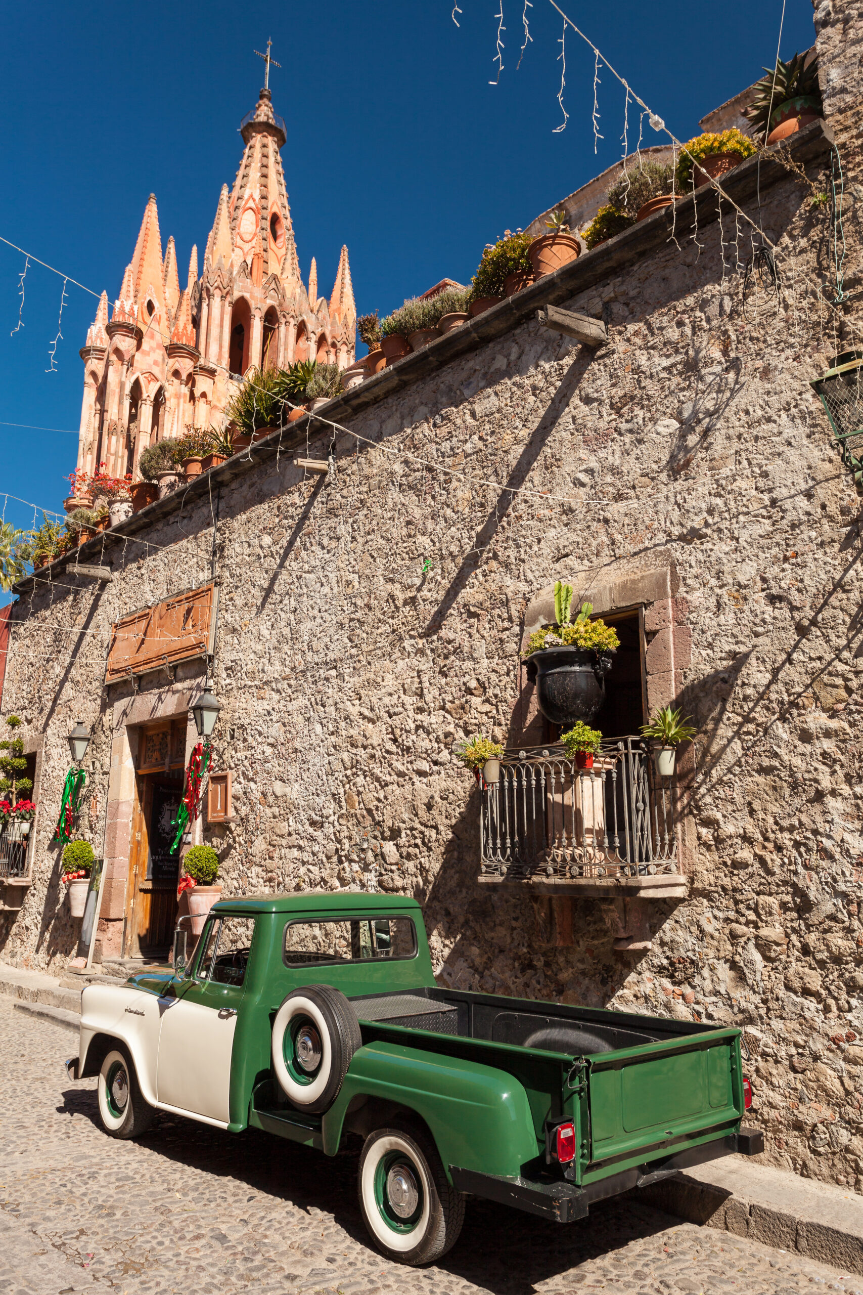 old pickup on the street in san miguel de allende with cathedral in background