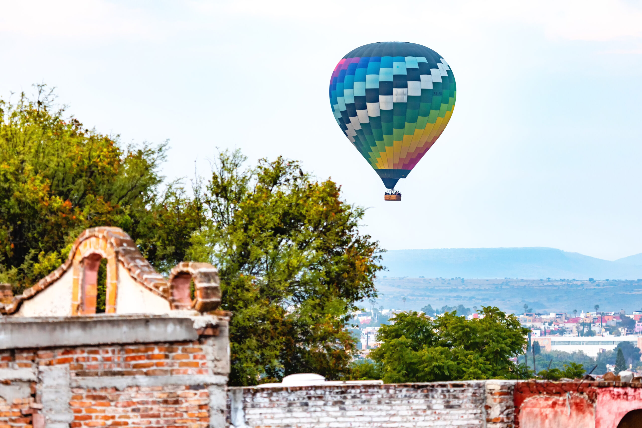 hot air balloon in the sky over san miguel de allende